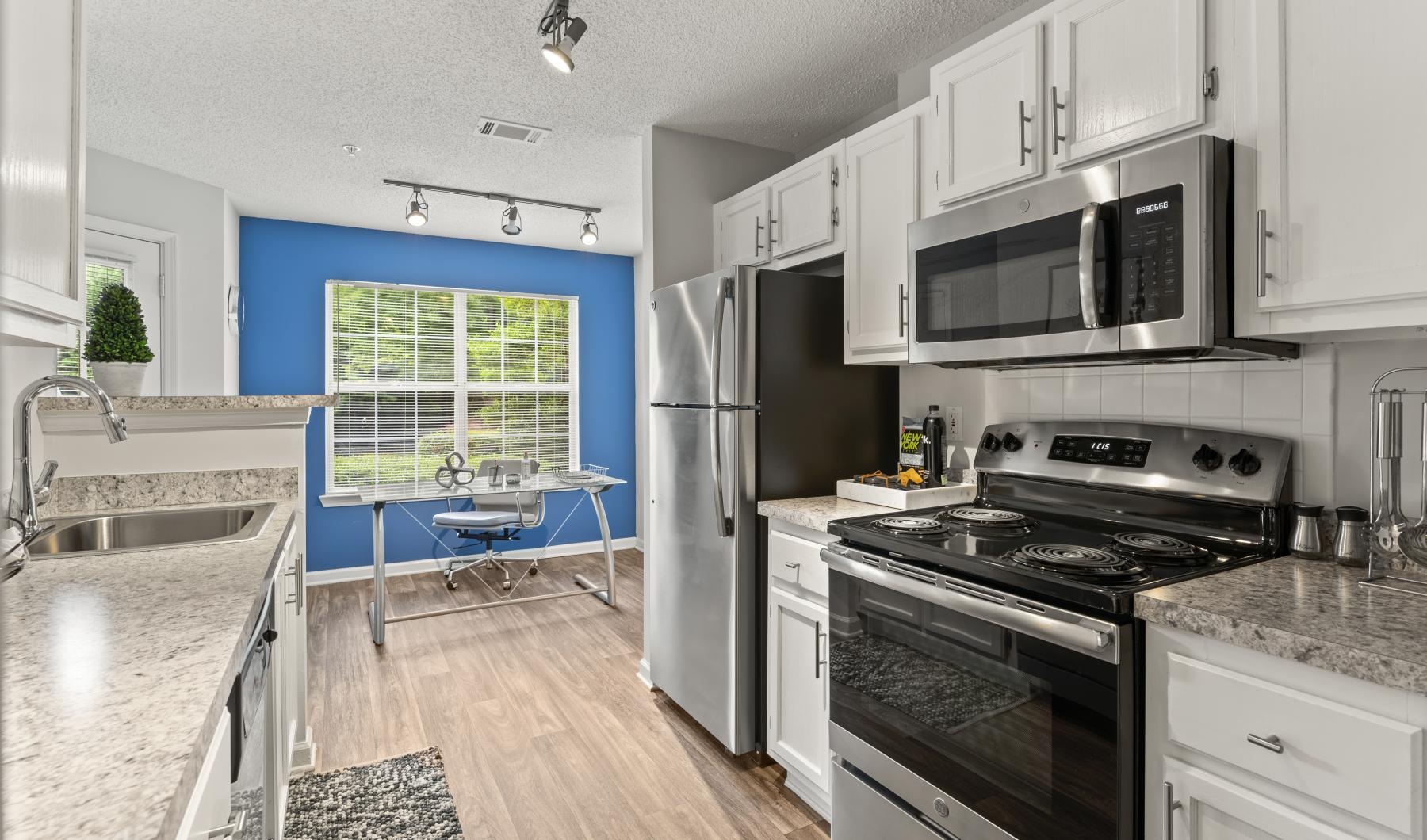 a kitchen with white cabinets